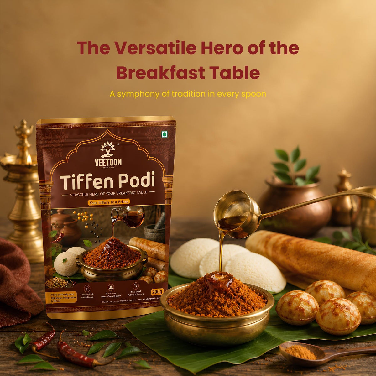 Veetoon Tiffen Podi 200g pouch – idli dosa podi (milagai podi) with a bowl of podi and gingelly oil poured over it, served with idli, dosa and paniyaram on a banana leaf