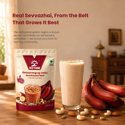 Glass of Red Banana Malt drink with red bananas, cashews and almonds on a table